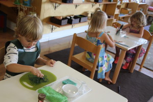 Beckett finger painting a cutting board